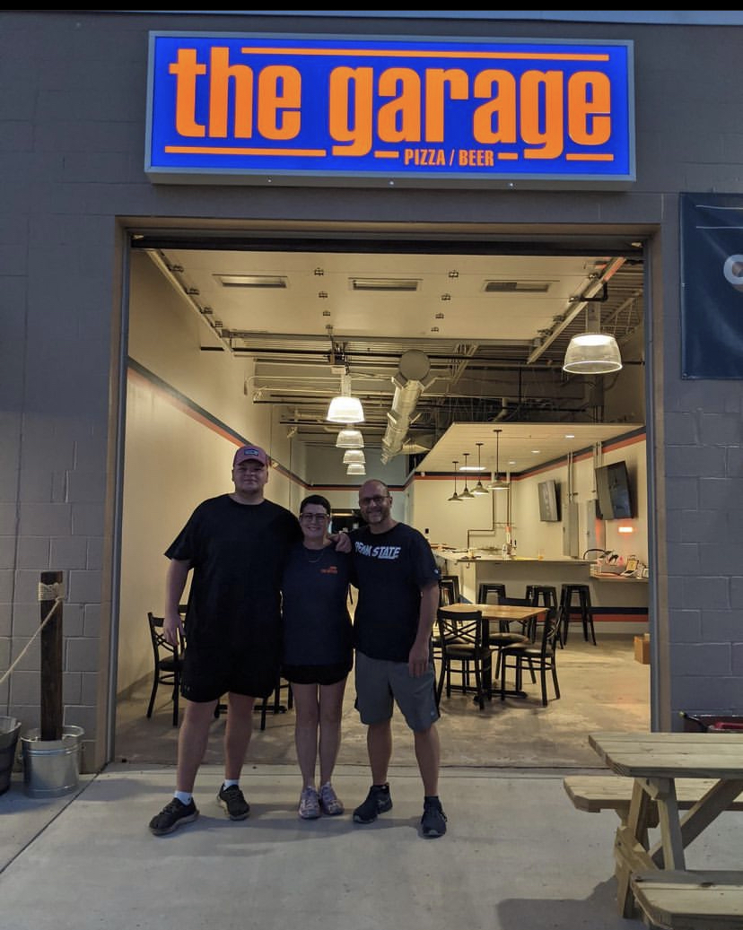 The Garage family standing at the Frederick restaurant entrance